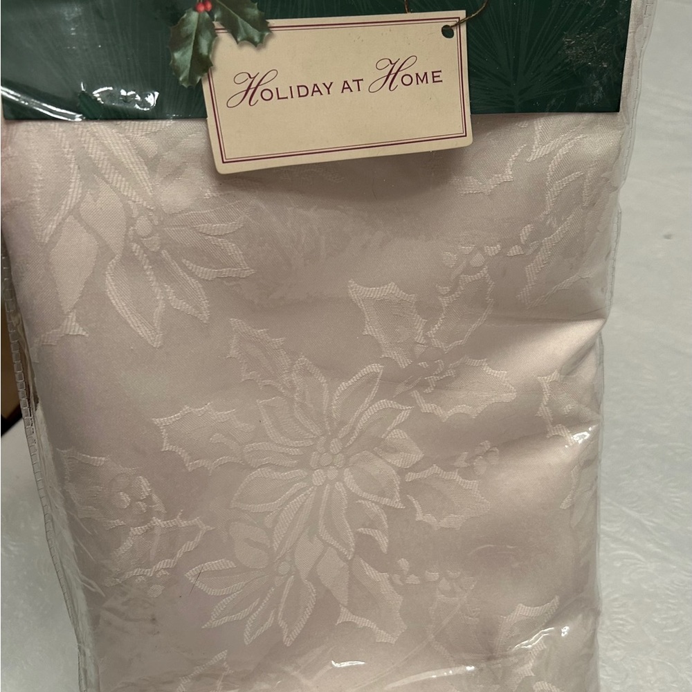 New in package. Ivory/cream 52”x70” oblong tablecloth.